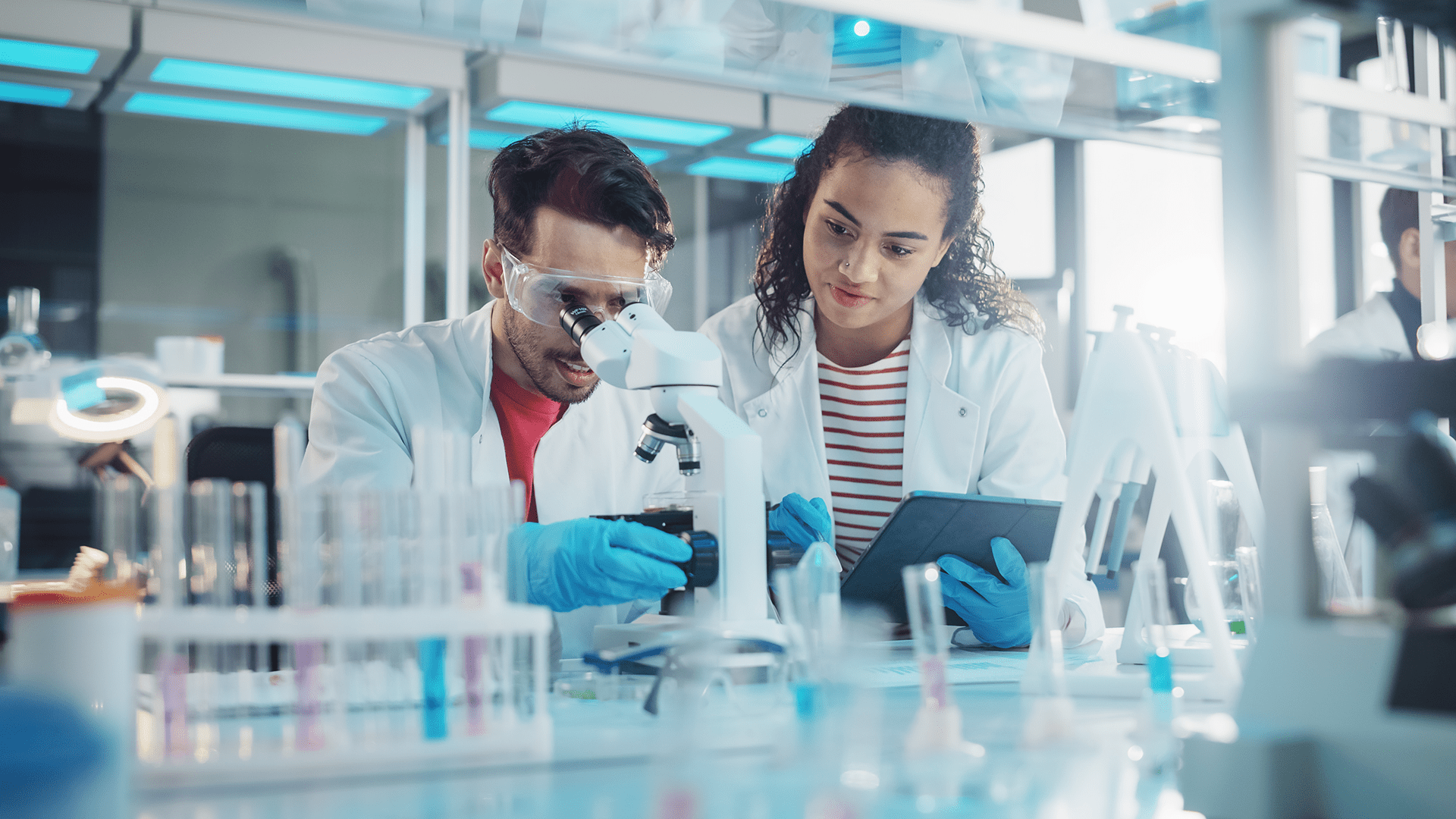 Scientists collaborating in a life sciences research facility representing a Center of Excellence 