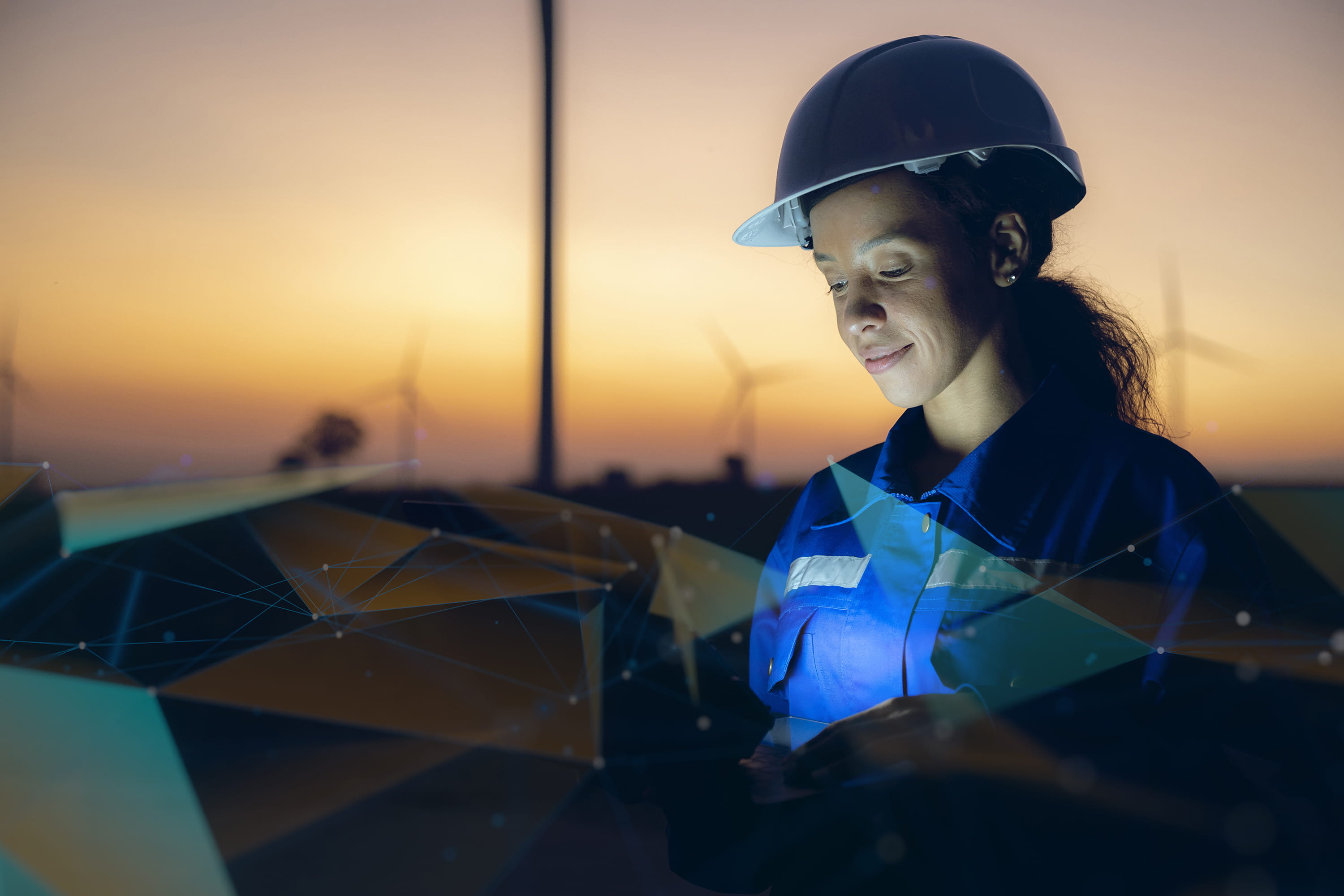 Female wearing a helmet amidst wind generator field Female wearing a helmet amidst wind generator field
